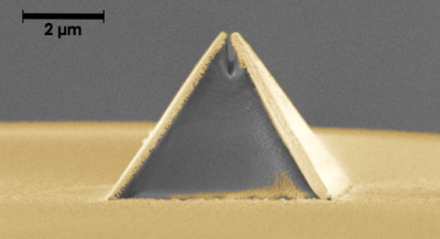 A new process called fibre nanoimprinting is accelerating the fabrication of nano-optical devices, such as this pyramid-shaped Campanile probe imprinted on an optical fibre (captured in a scanning electron microscope image). The gold layer is added after imprinting. The gap at the top is 70 nm wide. (Credit: Berkeley Lab)
