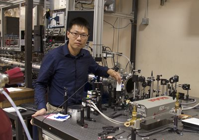 Researchers at Stanford University have developed a novel method for measuring hydroxyl radical (OH), a critical molecule in combustion reactions, with high sensitivity. This method uses frequency modulation of ultraviolet light to eliminate noise that hindered conventional methods from accurately detecting trace amount of OH in combustion environments and paves a pathway to new regimes of combustion research that were previously not accessible. Here, Shengkai Wang is aligning the UV laser beam through the combustion reactor. Credit: courtesy of Shengkai Wang, Stanford University
